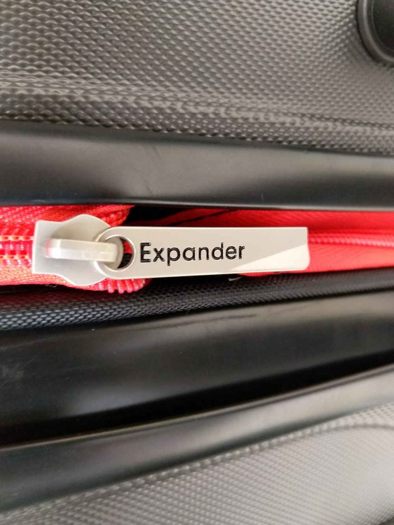 A carry on luggage zip with Expander write on it